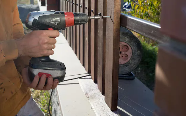 Drill fastening a wood fence rail
