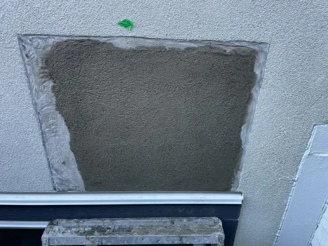 Patched hole in a drywall ceiling ready for finishing