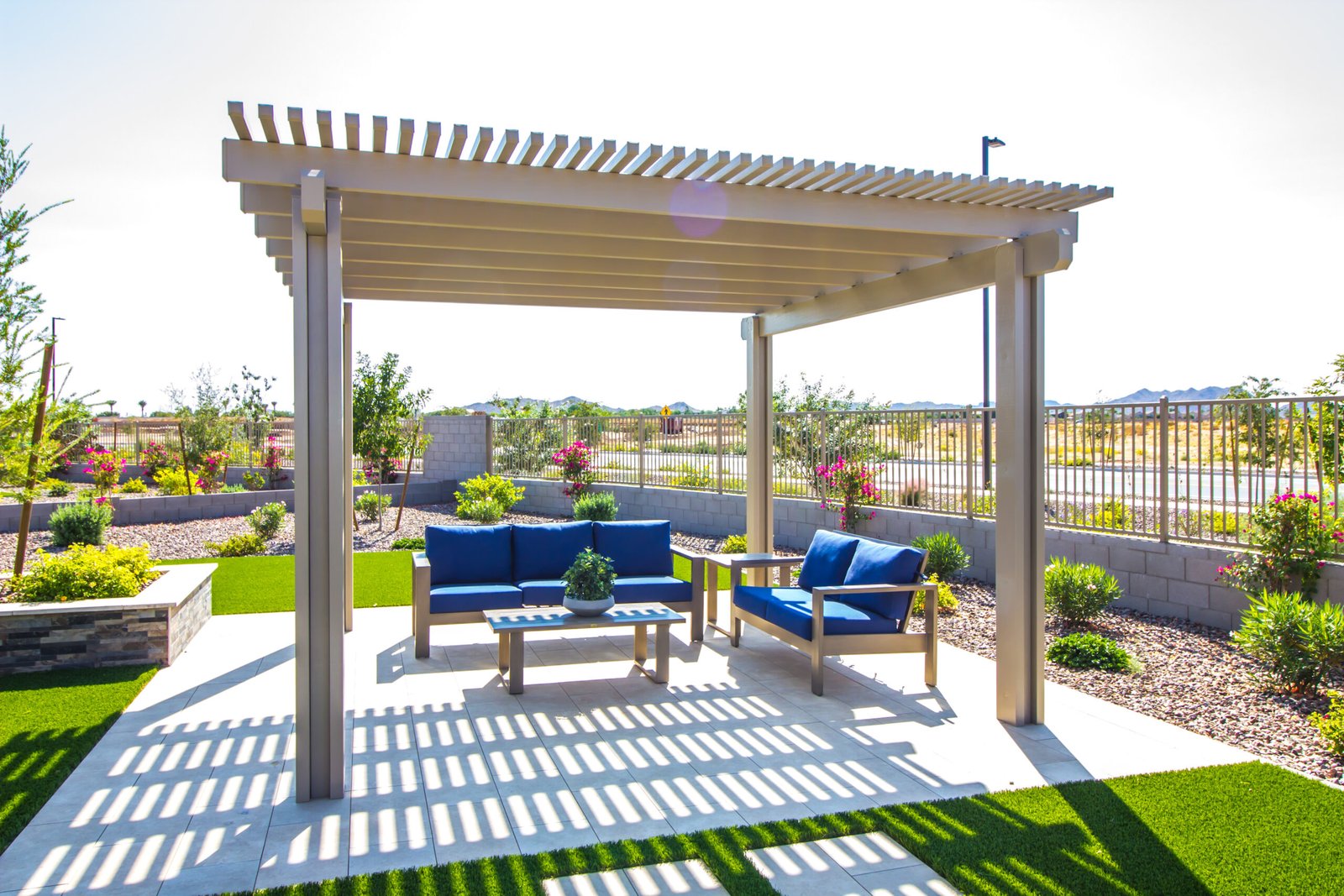 Backyard pergola shading blue patio sofas